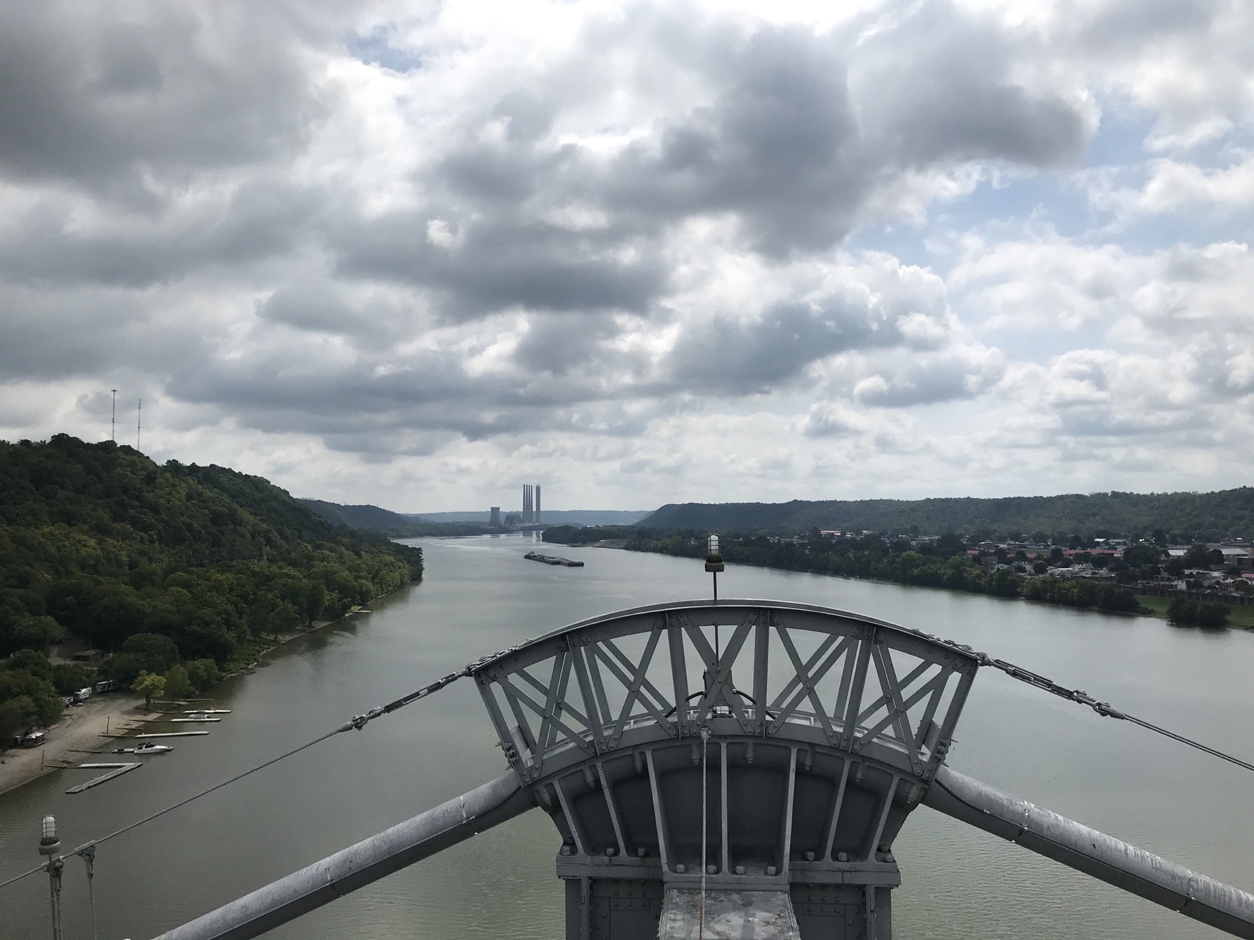 View over a steel bridge tower toward the Ohio River and wooded hills at Maysville, Kentucky